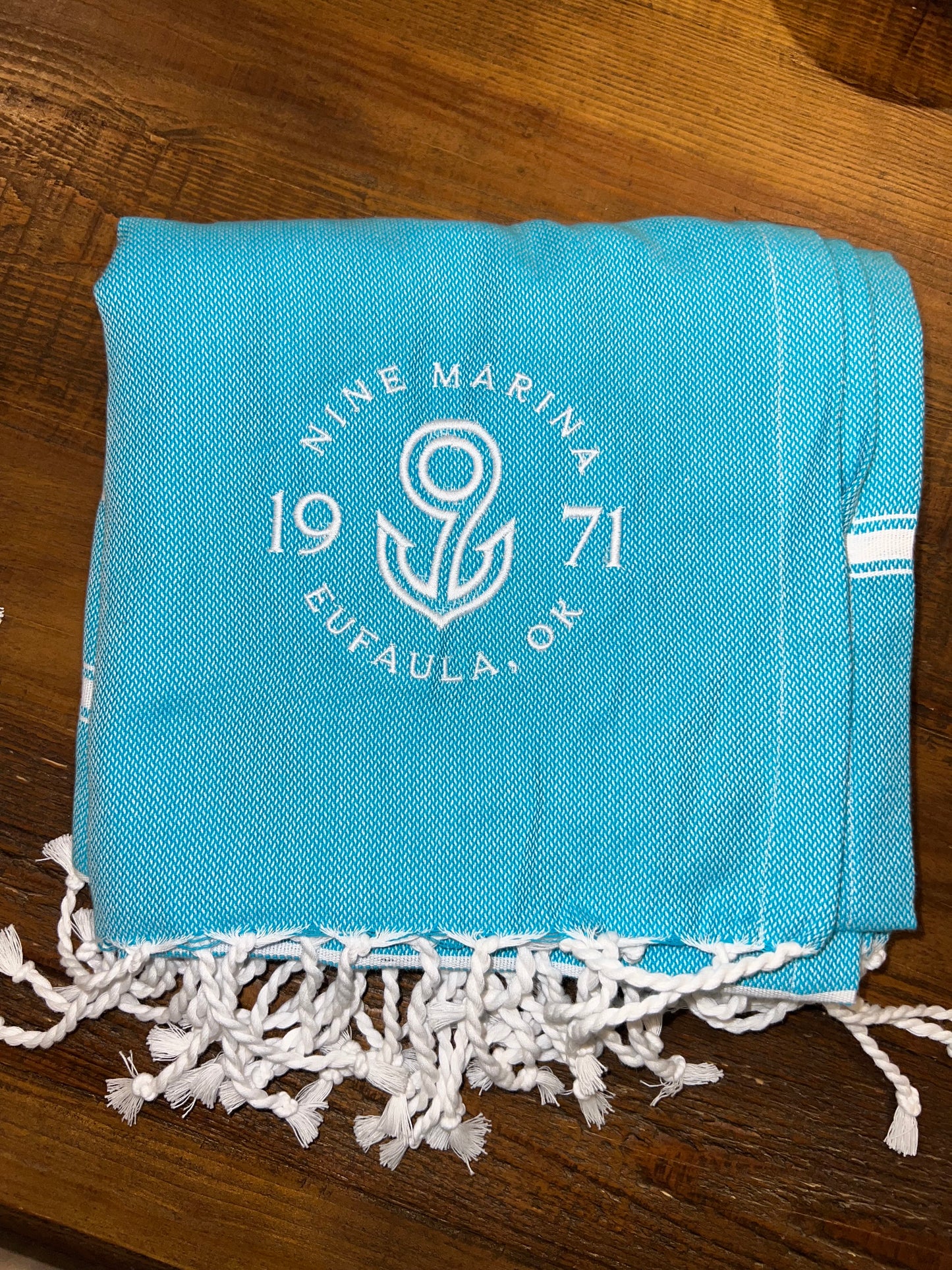 THROW BLANKET W/ EMBROIDERED BADGE LOGO