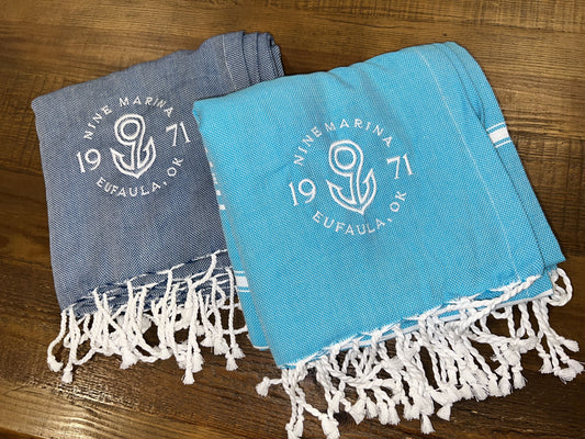 THROW BLANKET W/ EMBROIDERED BADGE LOGO